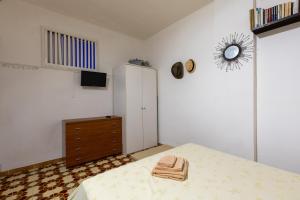a bedroom with a bed and a dresser and a mirror at Emma's Beach in Isola delle Femmine