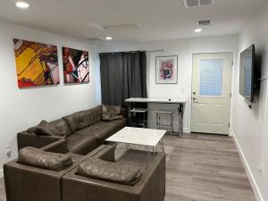 a living room with a couch and a table at Brand new private one bed one bath home with private parking for 2 in Van Nuys Airport