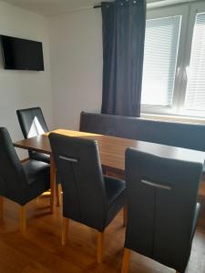 une pièce avec une table, des chaises et une télévision dans l'établissement Apartmánový dom Adriana, à Zuberec 10 autres photos