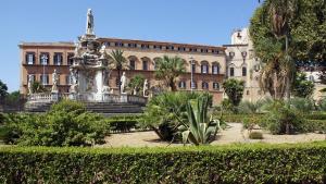 a fountain in front of a large building at Palermo - centro storico in Palermo