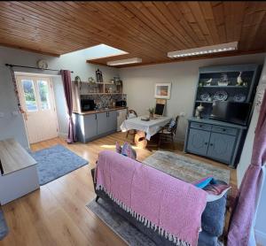 a living room with a couch and a table at The Burren Mill House in Bealaclugga