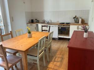 a kitchen with a wooden table and a table and chairs at Ferienwohnung "Storchennest" in Schwanau