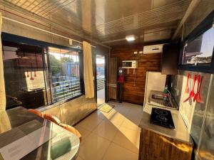 a kitchen with a counter and a sink in a room at Pousada Container Guarda do Embaú in Palhoça