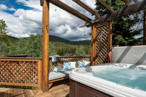 a hot tub on a deck with a view at Winter Park Ski Haus in Winter Park