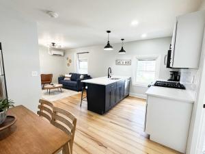 a kitchen and a living room with a table at Jennifer's Elegant & Cozy Broadway Retreat in Providence