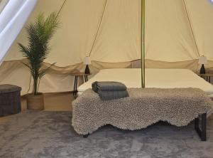 a bedroom with a bed in a tent at Siaröfortet in Norra Ljustero
