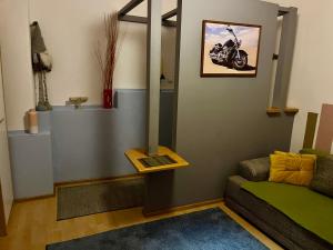 a living room with a motorcycle on the wall at Kawalerka Oaza Mnicha in Gdańsk