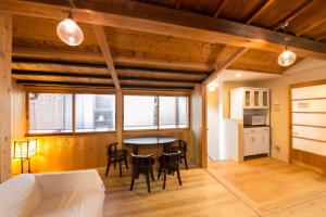 a kitchen and dining room with a table and chairs at Nagomi Ryokan Yu - Vacation STAY 79219v in Kyoto