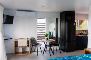 a kitchen with a table and chairs in a room at Muri Ocean View Villas in Ngatangiia