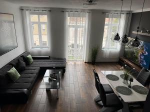 a living room with a couch and a table at NewPlace Luxury Apartment in Sátoraljaújhely