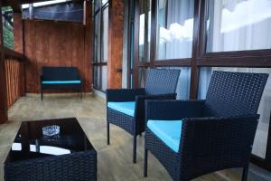 a group of chairs and a table in a room at Calm Home Apartment in Mestia