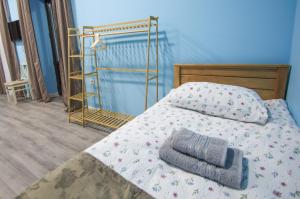 a bedroom with a bed with a pillow and a ladder at Calm Home Apartment in Mestia +56 photos