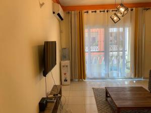 a living room with a television and a table at Summer luxury apartments in Mombasa