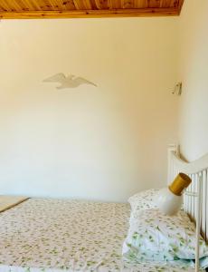 a bedroom with a bed with a bird on the wall at Pasithea Luxury Studio in Mikros Prinos
