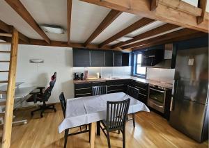 a kitchen with a table and chairs in a room at Koselig rekkehus i Longyearbyen in Longyearbyen