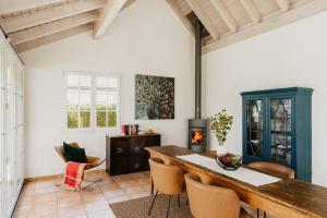 a living room with a table and chairs and a fireplace at Vogelbeer in Einsiedeln
