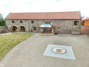 a large building with a greenhouse in front of it at The Estate, Luxury Spacious Family Stay with 3 Hot Tubs, Scenic Views Sleeps 16 near Durham & Bishop Auckland in Durham