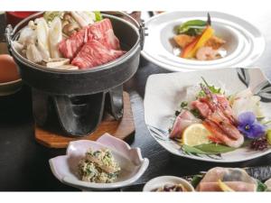 a table with plates of food on a table at Hotel Aoshima Cinqmale - Vacation STAY 67414v in Miyazaki