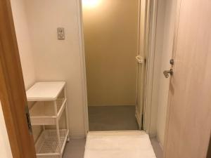 a small bathroom with a door open to a closet at Utano Youth Hostel - Vacation STAY 50485v in Kyoto