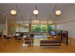 a lobby with couches and chairs and a television at Utano Youth Hostel - Vacation STAY 50485v in Kyoto
