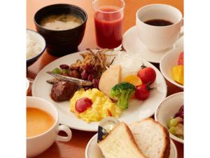 a table with a plate of breakfast foods and coffee at Hotel Aoshima Cinqmale - Vacation STAY 67415v in Miyazaki +9 photos