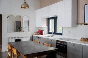 a kitchen with a table and chairs in it at Villa Restart in Bijeljina