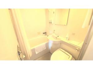 a white bathroom with a toilet and a sink at Smile Hotel Kitaasaka - Vacation STAY 69671v in Asaka +8 photos