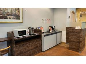 a kitchen with a microwave on top of a counter at Smile Hotel Kitaasaka - Vacation STAY 69671v in Asaka