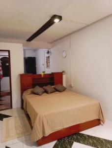 a bedroom with a bed and a flat screen tv at Studio - Chantilla Vie in Trou aux Biches +19 photos