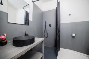 a bathroom with a black sink and a mirror at Arzachena centro 10 min from Costa Smeralda in Arzachena