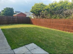 a backyard with a fence and a grass yard at A home in Bundoran in Bundoran