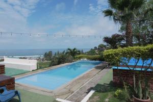 a swimming pool with a view of the ocean at Punta Hills Montanita in Montañita