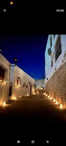 a street at night with lights on the sides of buildings at Casa Walt in Mojácar
