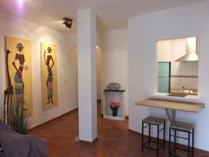 a living room with paintings on the walls and a table at Casa Walt in Mojácar