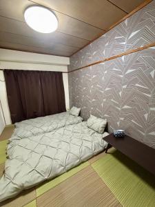 a small bedroom with a bed and a table at 瀬戸雲来seto unrai4 in Takamatsu
