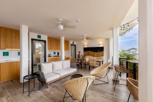 a living room with a couch and chairs at Raices Nomadas Boutique Hotel Vallarta in Puerto Vallarta