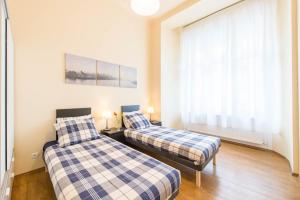 Un pat sau paturi într-o cameră la API Flat
