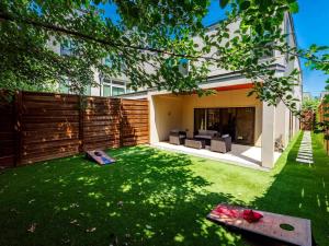 a backyard with green grass and a house at Stylish Retreat Great Location Patio Parking in Dallas