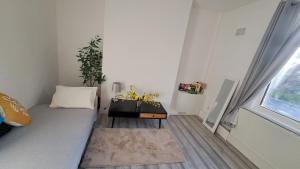 a small room with a bed and a table at 2 bedroom Large House For Contractors, And Family with a sofa bed in Shildon