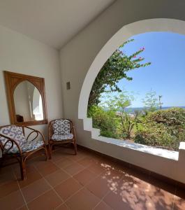 a room with two chairs and a large window at Domina Coral Bay Private Studios - Oasis - Blocco 34 in Sharm El Sheikh