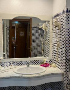 a bathroom with a sink and a large mirror at Domina Coral Bay Private Studios - Oasis - Blocco 34 in Sharm El Sheikh