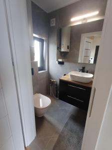 a bathroom with a white sink and a toilet at Przystań Łukęcin in Łukęcin +37 photos