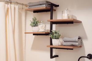 a bathroom with wooden shelves on the wall with towels at Huge, One Bedroom Apartment with Balcony in Conneaut Lake