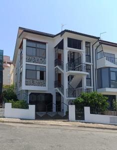 a white apartment building with balconies on a street at A&B Apartments - Afonso in Macedo de Cavaleiros