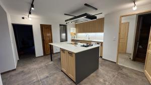 an empty kitchen with a island in the middle at La Catiche des Loutres in Revel