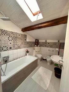 a bathroom with a tub and a toilet and a sink at Apt Versilia in Viareggio +56 photos