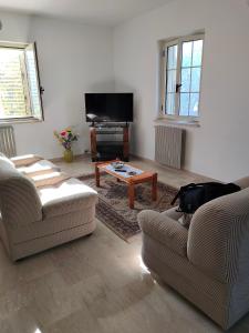 a living room with two couches and a coffee table at Holiday Calabria Rooms in Lamezia Terme