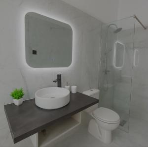 a white bathroom with a sink and a toilet at Endless Green Villa in Argostoli +12 photos