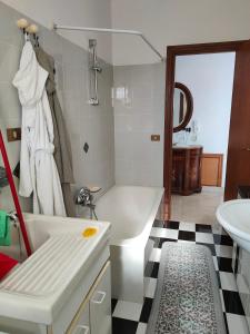 a bathroom with a white tub and a sink at Holiday Calabria Rooms in Lamezia Terme +39 photos