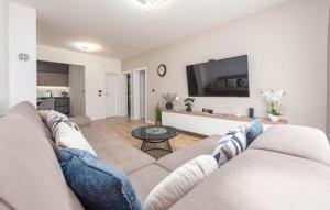 a living room with a couch and a table at Luxe Holiday Home in Posedarje